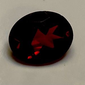 Approximately 7 x 9 mm oval garnet gemstone
